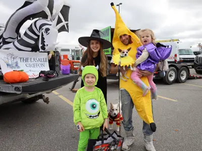 A family wearing halloween costumes.