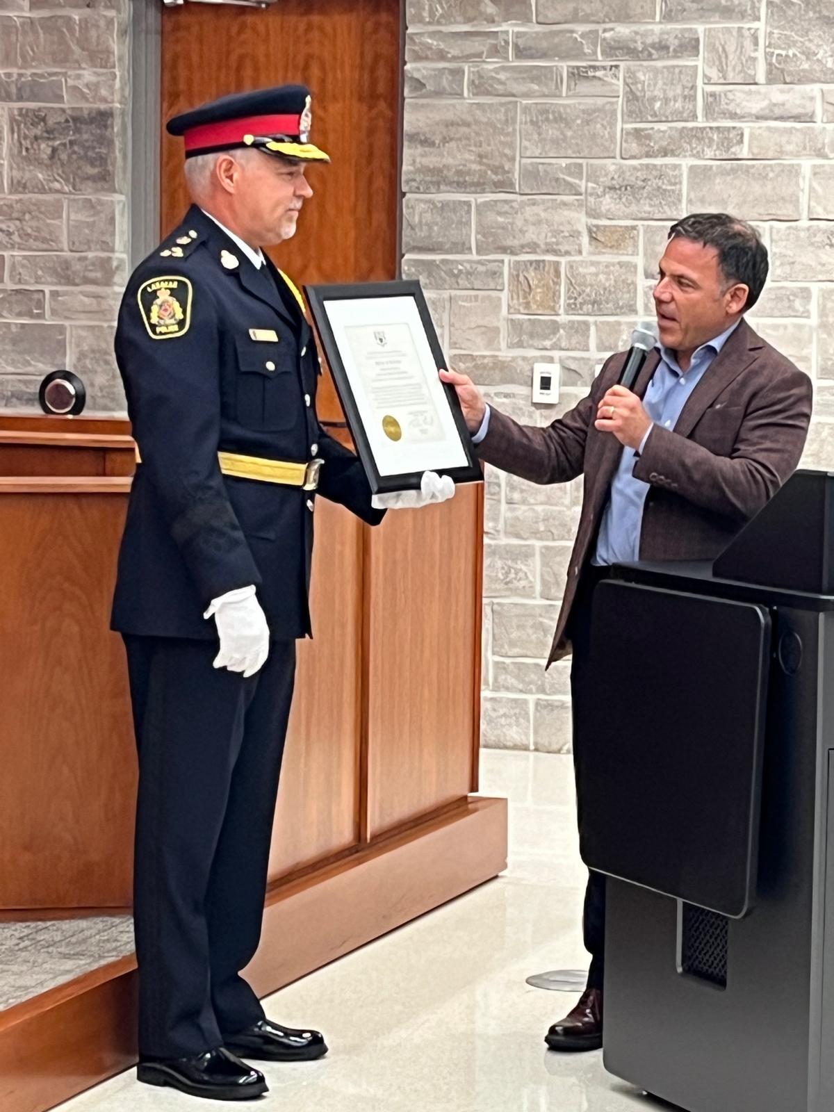 Person handing police officer a certificate