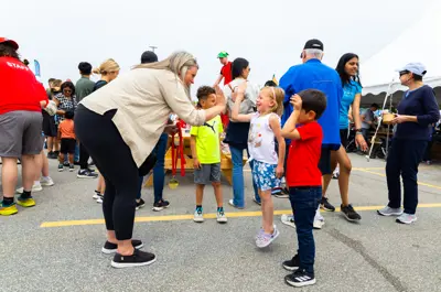 Mayor Meloche high-fiving children.