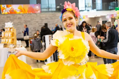 A woman in a yellow flower costume.