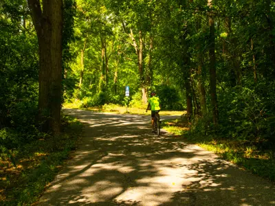 Person riding a bike down Brunet Park Trail.