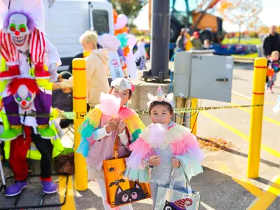 Children in costumes eating cotton candy.