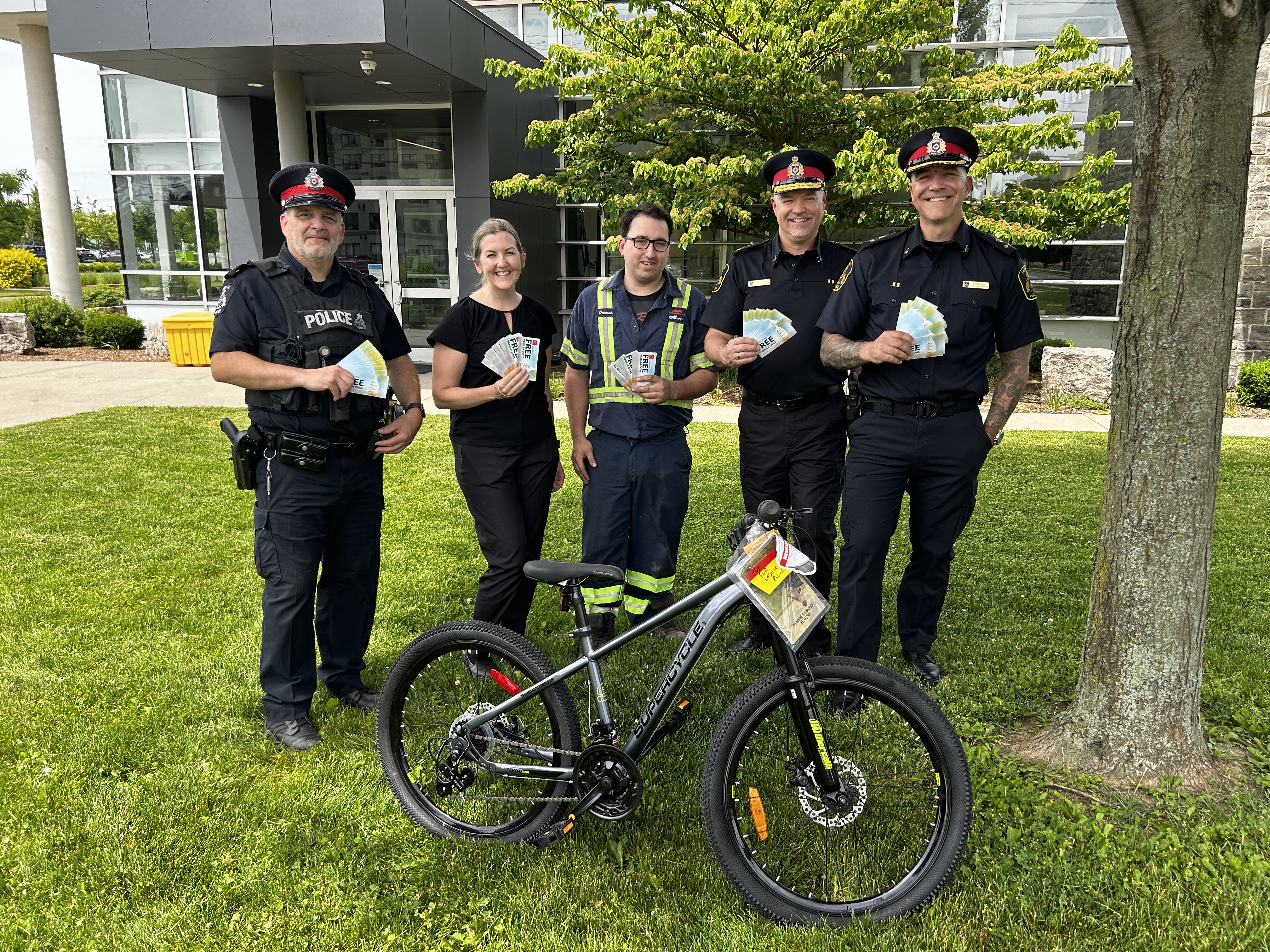 three police officers, two other people and a bicycle