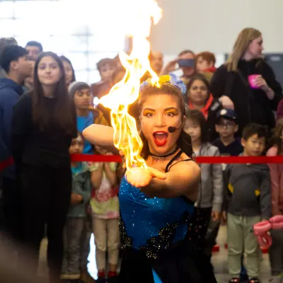 Fire busker in front of a crowd.