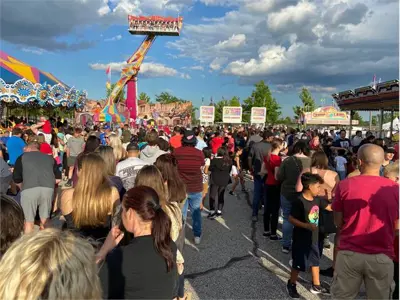 A crowd of people at the Strawberry Festival.