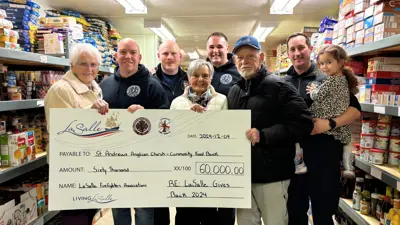 people holding a large cheque