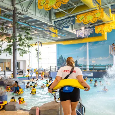 Lifeguard overlooking a busy pool.