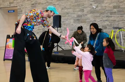 Child receiving a balloon animal.
