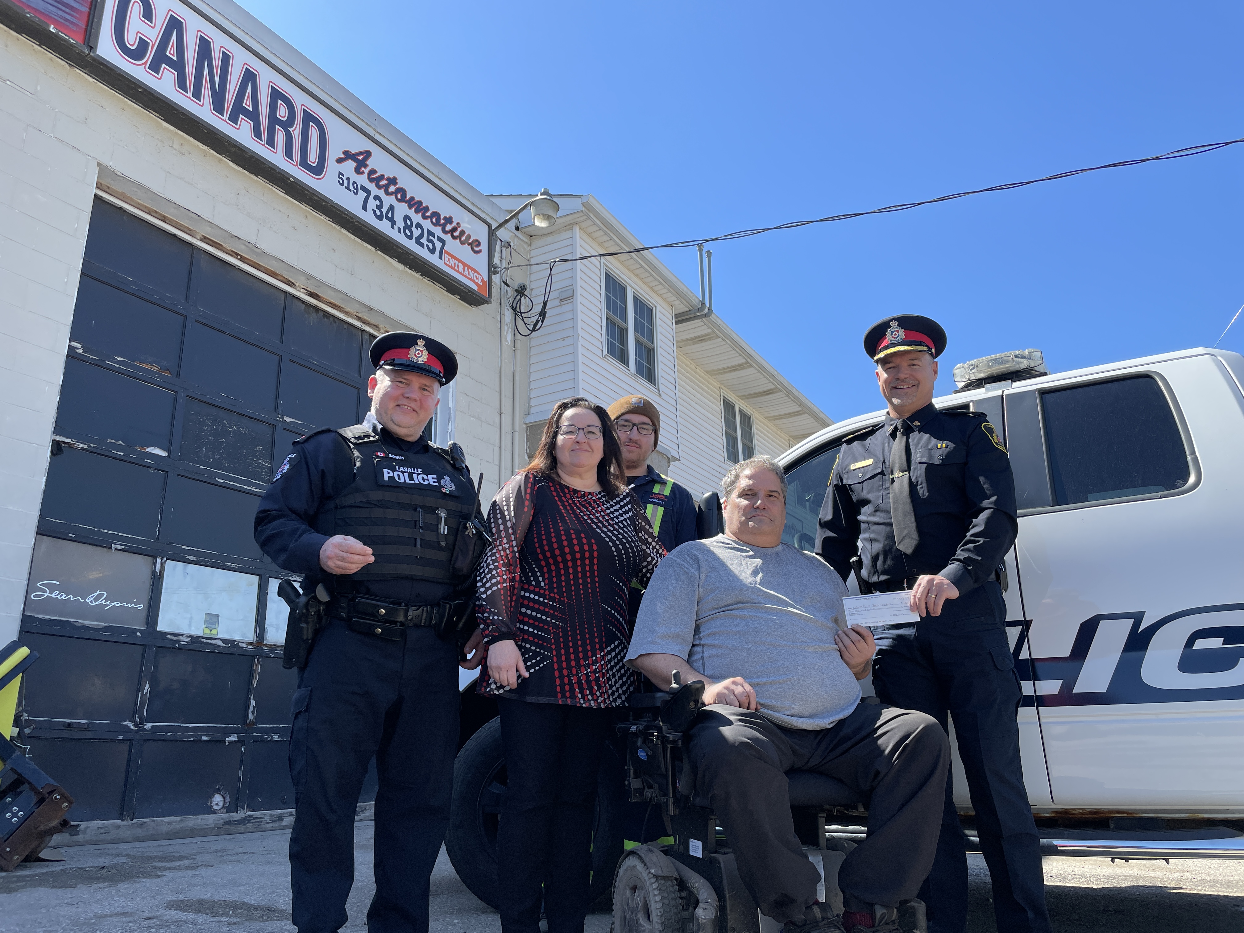 Photo of four people in front of business