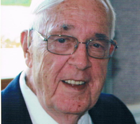 Howard Paddon in a suit smiling