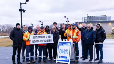 A group of people holding a sign.