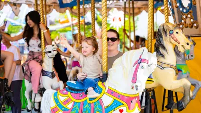 Young child riding a merry-go-round.