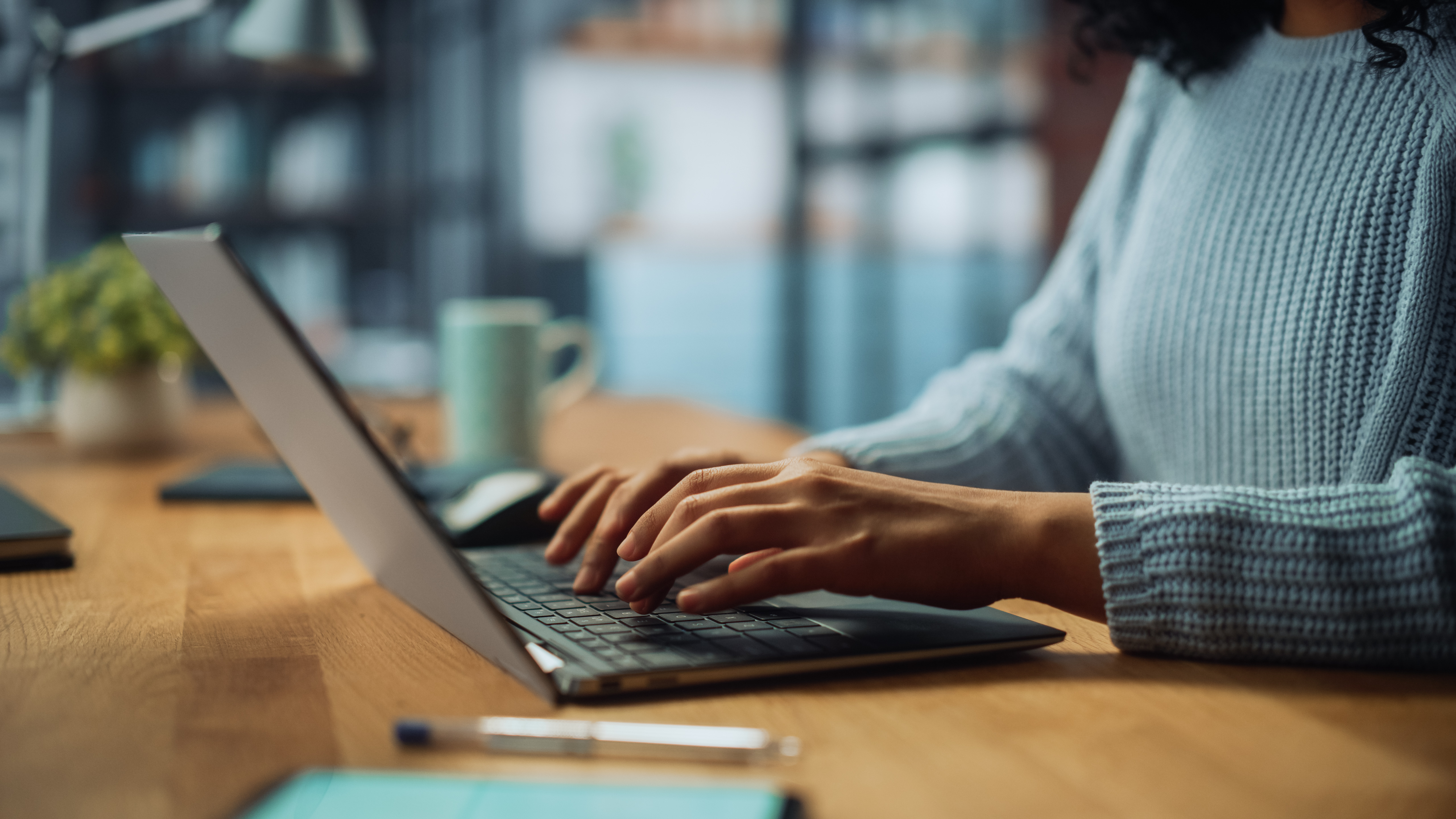 Person typing on a laptop stock image.