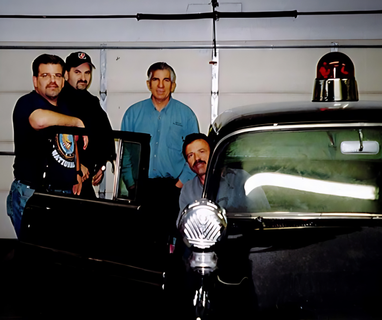 People standing near old police car