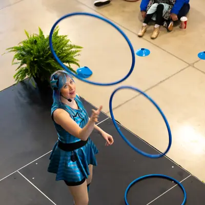 Performer throwing hoola hoops.