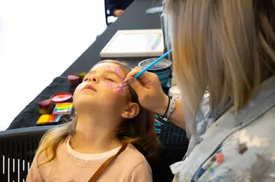 Child getting their face painted.