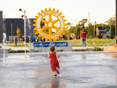 Child running through a splashpad.