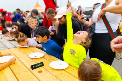 Children participating in a strawberry eating contest.